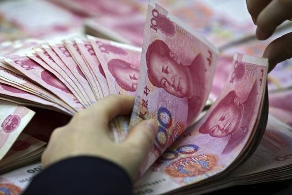 Why has the U.S. accused China of deliberately weakening the yuan?